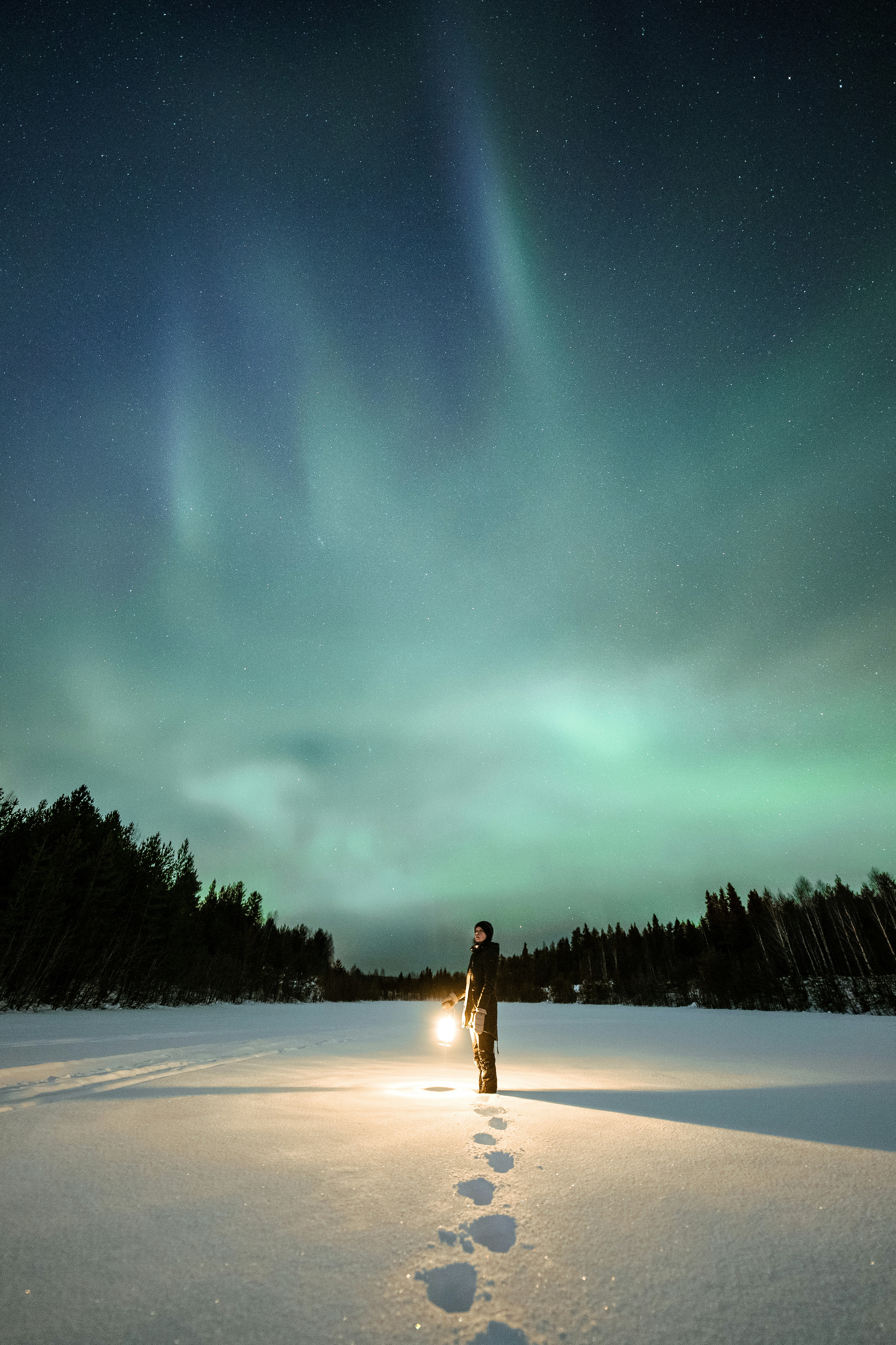 woman in white dress standing on snow covered ground during night time